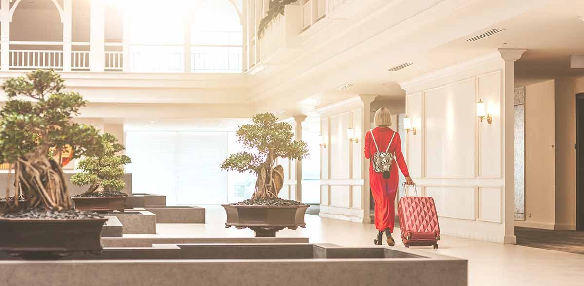 businesswoman walking through a hotel lobby