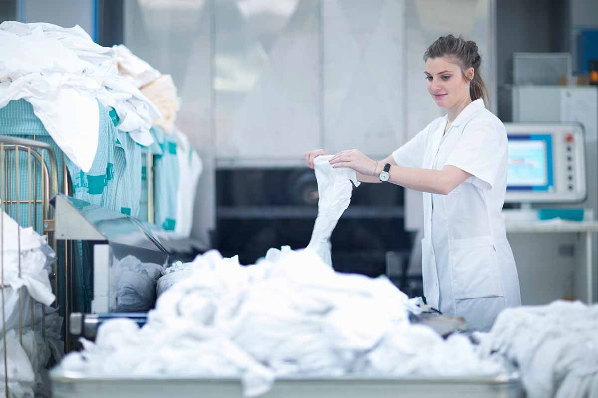 woman working in commercial laundry facility